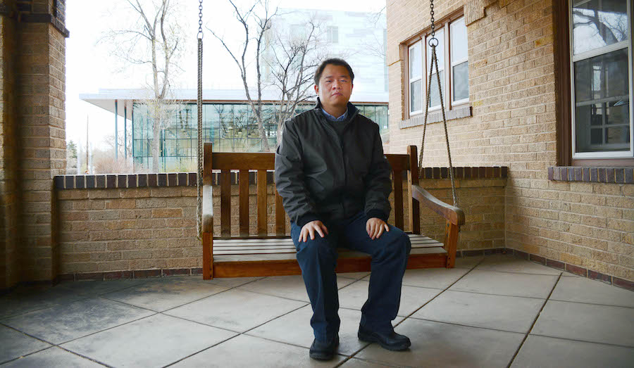 Rui Zhao sits on the swing on the porch of Coolbaugh House at Mines.